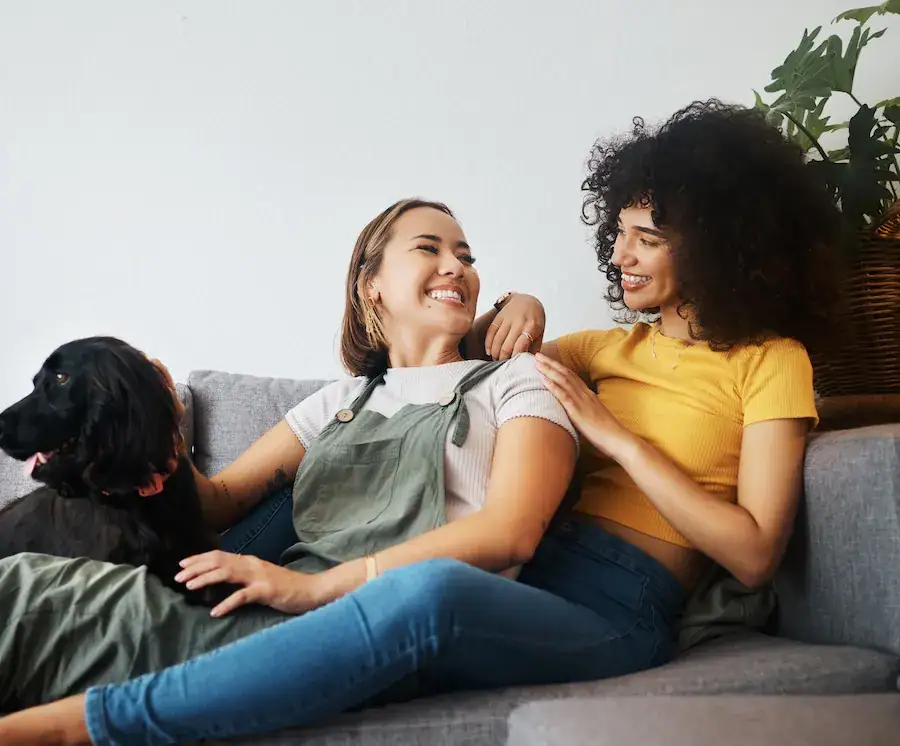 couple sitting on couch with dog