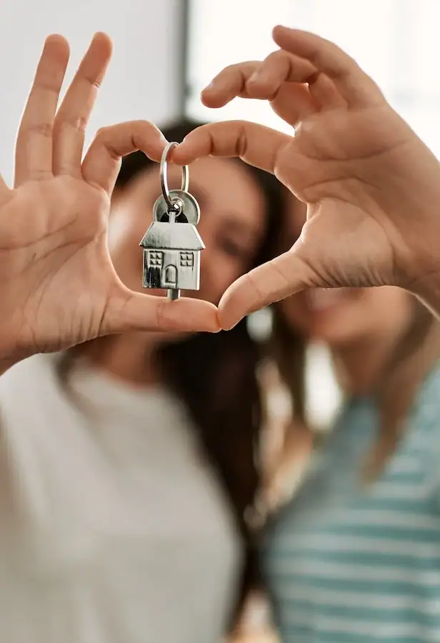 lesbian couple holding keys to new home