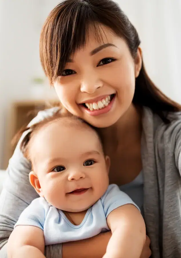 mom posing with smiling baby