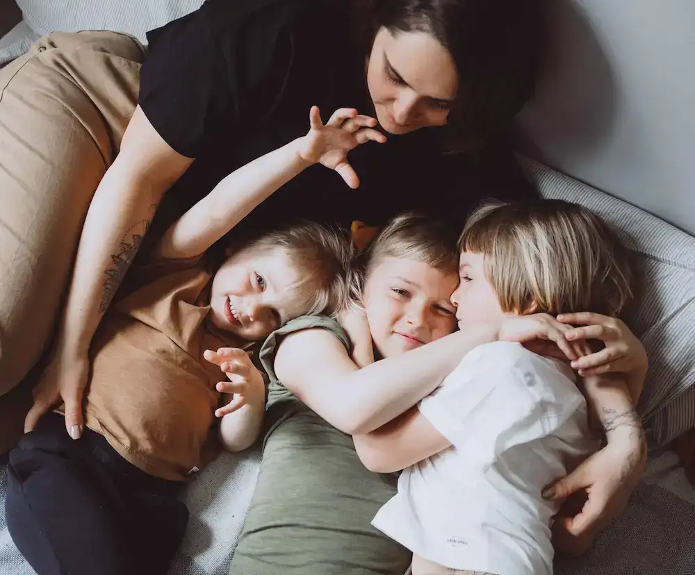 single mom by choice laying with her kids