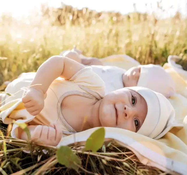 twins laying in grass